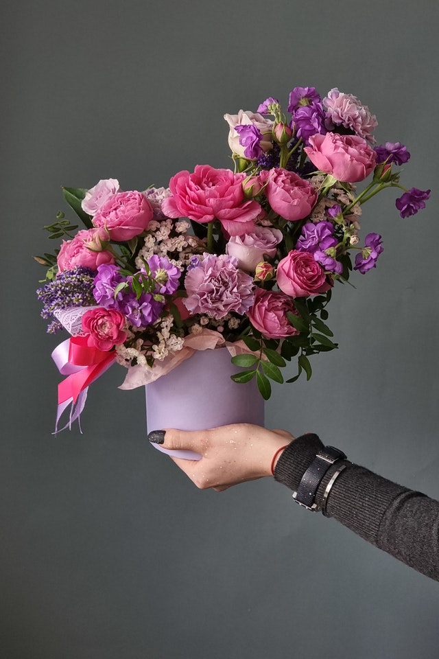 boxed bouquet of mixed flowers in pink and lilac colours